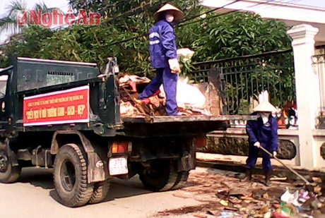 Công nhân Công ty CP Đầu tư và phát triển môi trường TX. Hoàng Mai giúp dân thu dọn rác thải sau cơn bão số 10.