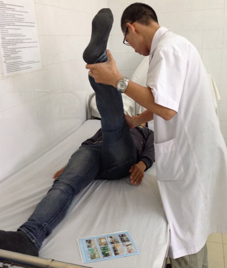 Bác sĩ Phạm Quang Thuận xem xét tình hình cơ xương khớp của bệnh nhân. 