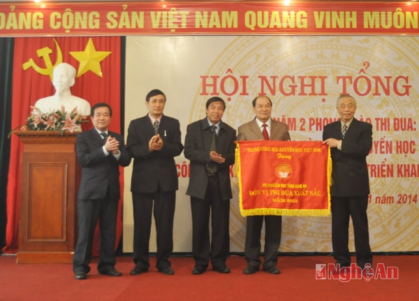 Đồng chí Nguyễn Mạnh Cầm trao cờ thi đua và bằng khen của Trung ương hội cho Hội Khuyến học tỉnh.