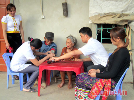 Cán bộ y tế xã Hữu Kiệm (Kỳ Sơn) đến khám chữa bệnh cho dân bản tại nhà. Ảnh: Công Kiên