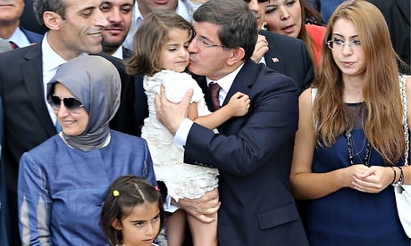 Thủ tướng Thổ Nhĩ Kỳ Ahmet Davutoglu ôm hôn con gái của Tổng lãnh sự khi cô bé được trả về cùng 45 con tin khác.