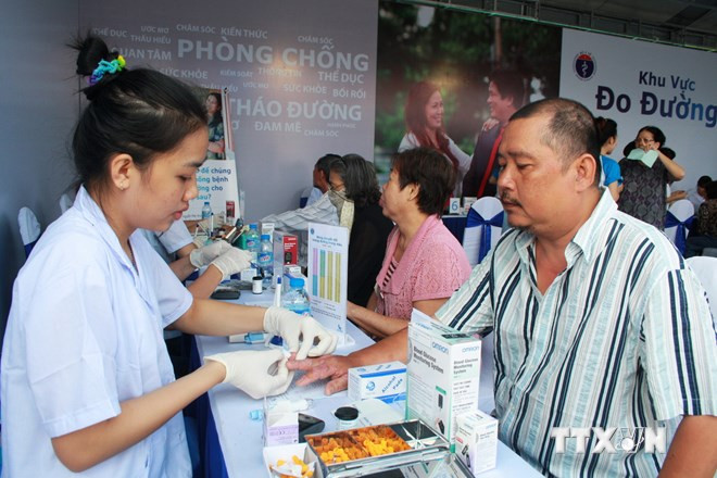 Người dân được nhân viên y tế thử máu, kiểm tra lượng đường huyết tại Ngày hội Phòng chống bệnh Đái tháo đường năm 2013 ở Hà Nội. Ảnh: TTXVN