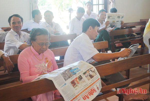Đại biểu đọc báo trong giờ giải lao