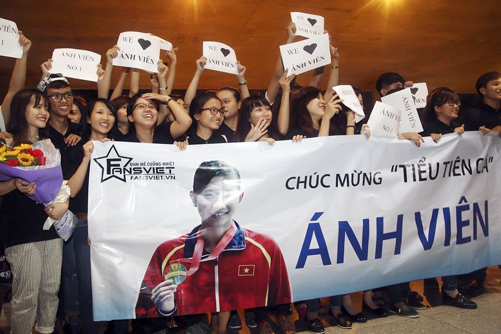 Theo lịch trình, 21h30 tối 12/6 chuyến bay chở Nguyễn Thị Ánh Viên cùng HLV Đặng Anh Tuấn mới đáp xuống sân bay quốc tế Tân Sơn Nhất. Nhưng từ 20h, hàng trăm người hâm mộ cũng như phóng viên các cơ quan báo đài đã có mặt để chuẩn bị đón chào nữ kình ngư số một của Việt Nam.
