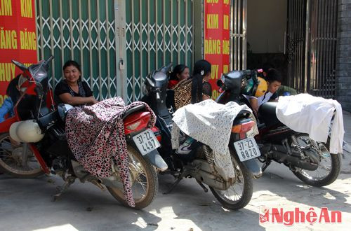 Những chiếc xe máy đã được các phụ huynh đưa các em học sinh đi thi che chắn để chống lại với nắng nóng.