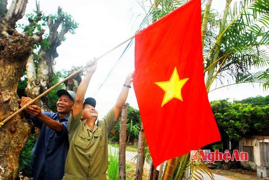 Nhân dân xóm Minh Cao treo cờ Tổ Quốc đón chào sự kiện  xã về đích NTM