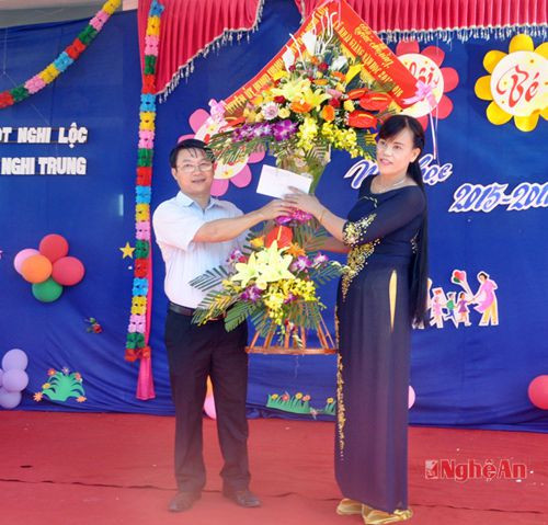 Đại diện lãnh đạo huyện Nghi Lộc tặng hoa chúc mừng Trường Mầm non xã Nghi Trung nhân  dịp khai giảng năm học mới.