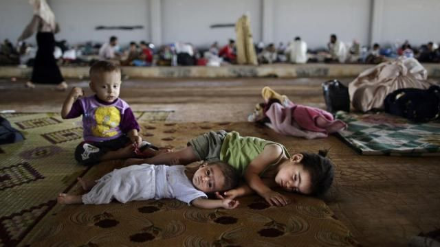 Trẻ em Syria di cư theo gia đình. Ảnh: Occupy.com