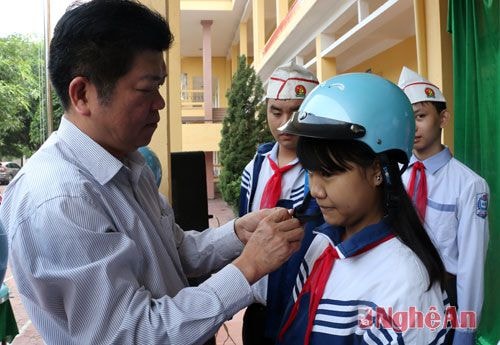 Tặng mũ bảo hiểm và hướng dẫn học sinh đội mũ bảo hiểm đúng cách