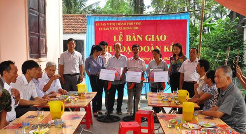 Đại diện MTTQ thành phố Vinh, lãnh đạo xã Hưng Hòa trao quà và giấy chứng nhận nhà Đại đoàn kết cho 4 gia đình