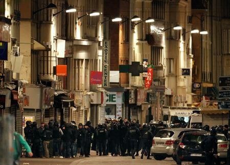 Lực lượng đặc nhiệm Pháp tại khu vực xảy ra nổ súng ở Saint-Denis, gần Paris hôm 18/11 trong chiến dịch truy bắt những kẻ lẩn trốn sau loạt vụ tấn công Paris đêm 13/11. Ảnh: Reuters.