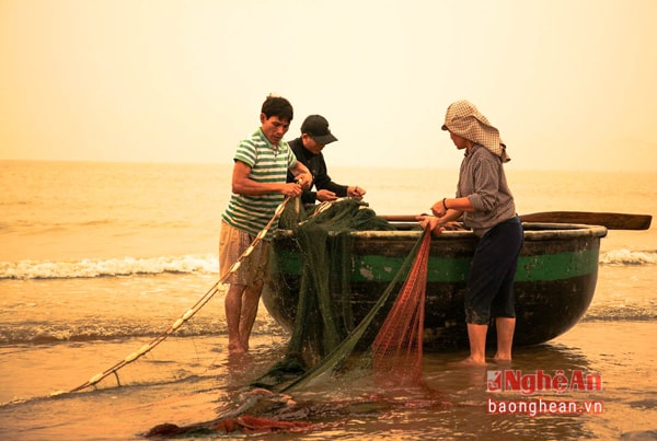 A family collects nets in the early morning.