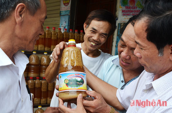 Đại diện Làng nghề và một gia đình bán tương tư vấn cho khách hàng cách phân biệt tương chất lượng và an toàn sản xuất tại Làng nghề và tương sản xuất trôi nổi trên thị trường.