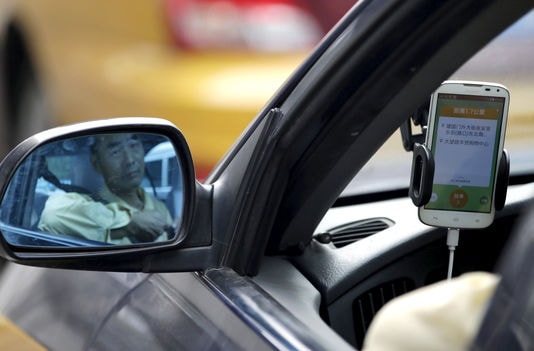 Apple chọn Didi - đối thủ của Uber tại Trung Quốc - để bắt đầu “cuộc cách mạng”? Ảnh: Reuters