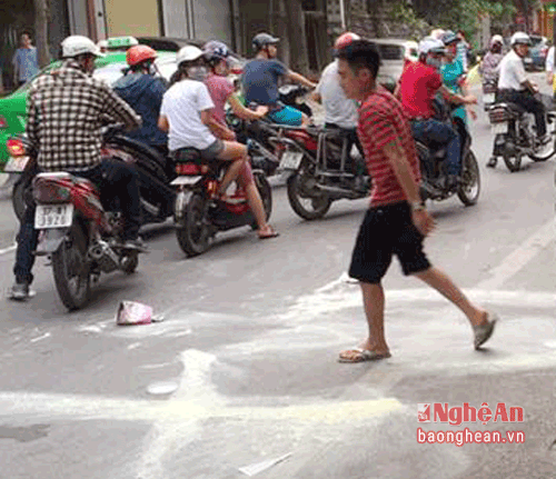 Nguyễn Cảnh Cường lấy 5 hộp sữa trong siêu thị ném ra ngoài đường trước sự chứng kiến của nhiều người dân. (ảnh chụp ngày 14/7)