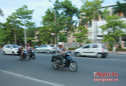 Người dân vừa đi xe vừa nghe điện thoại.