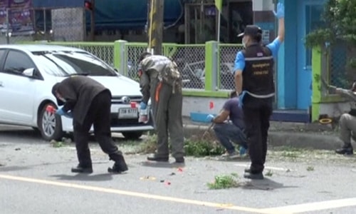 Police raise their hands as they check the scene after two bomb blasts in the southern province of Surat Thani, Thailand in this still image from video August 12, 2016. REUTERS/Reuters TV