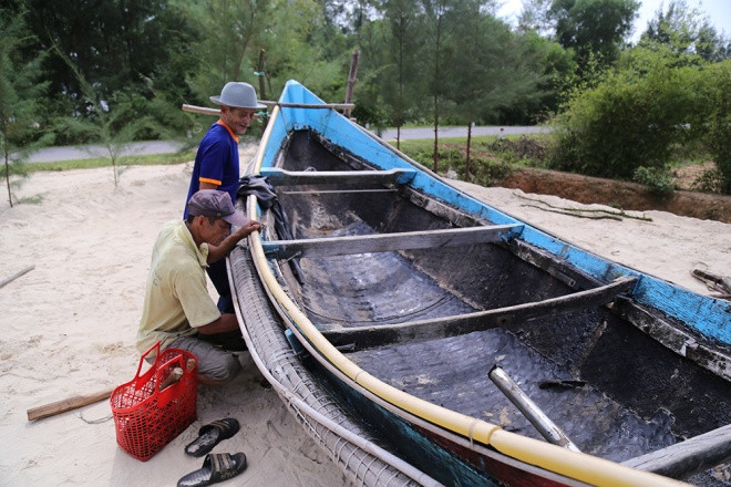 Ông Sơn (huyện Gio Linh, Quảng Trị) cùng con trai đưa chiếc thuyền nan 90CV lên bờ để tu sửa, chờ mùa biển mới. “Hy vọng cuối tháng 8 âm lịch, biển lại có cá để ngư dân chúng tôi ra khơi”.