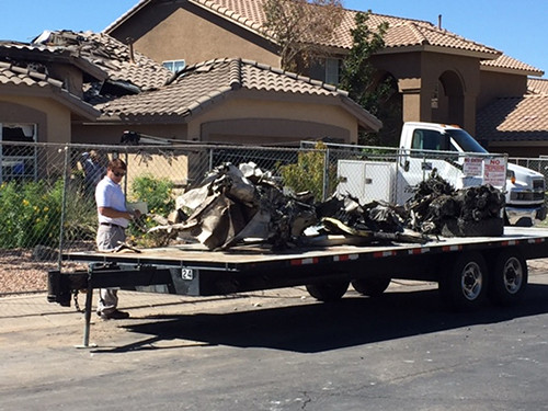 [Caption]Wreckage from a plane that crashed into a home in Gilbert, Ariz., sits on a flatbed on Sunday, Sept. 18, 2016.
