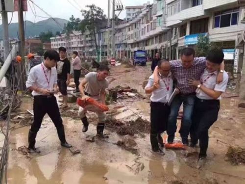 [Caption]quan chức Chiết Giang đã bị sa thải sau khi bức ảnh chụp ông được cõng qua đoạn đường bùn lầy