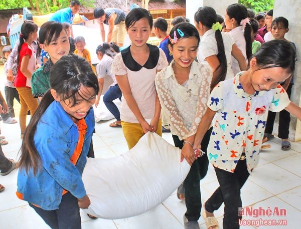 Niềm vui của các em học sinh Trường THCS Tam Hợp (Tương Dương) khi được nhận gạo hỗ trợ.