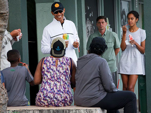 President Barack Obama eats shave ice with daughter Malia, at right, at Island Snow, Jan. 1, 2015, in Kailua, in Hawaii during the Obama family vacation.