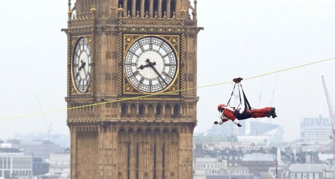 Một lính cứu hỏa đang vượt sông Thames bằng cách đu dây như người nhện vào ngày 2/12 tại London, Anh. Đây là hoạt động nằm trong chương trình gây quỹ từ thiện.