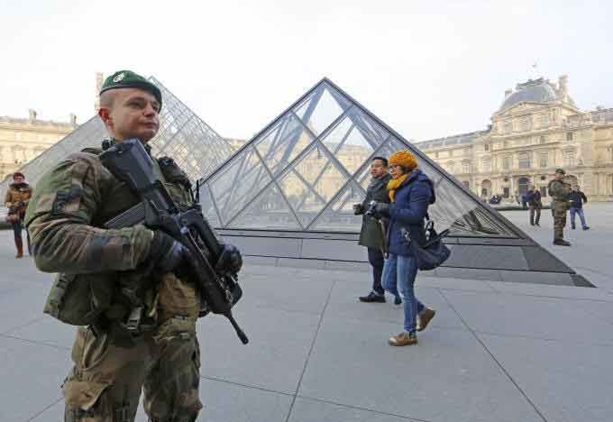 Lính vũ trang giám sát an ninh trên quảng trường Bảo tàng Louvre, Paris, Pháp (Ảnh: Ria Novosti)