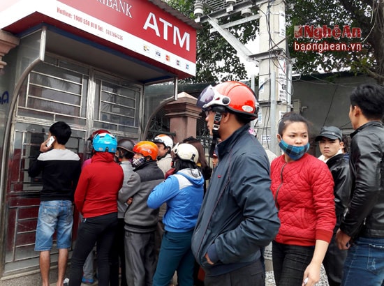 Mọi người cố chen vào cột ATM để rút tiền. Ảnh Lê Nhung