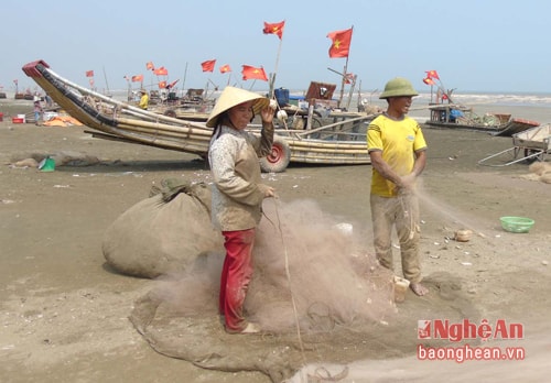 Với chiếc bè nứa, người phụ nữ ở Hòn Câu, xã Diễn Hải (Diễn Châu) vẫn hàng ngày ra biển đánh cá để nuôi các con ăn học. Ảnh: Tiến Dũng