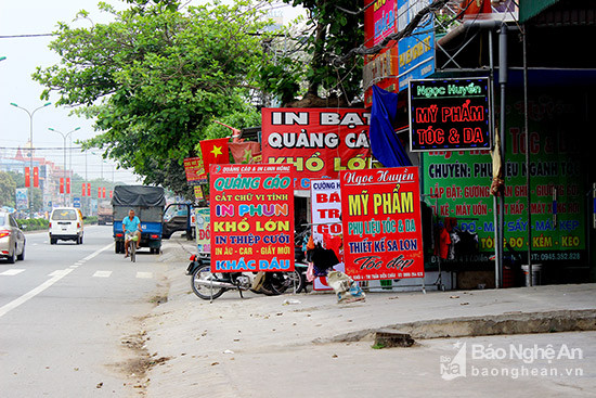 hiều biển quảng cáo mọc lên tại khối 4, TT Diễn Châu. Ảnh: Quang An