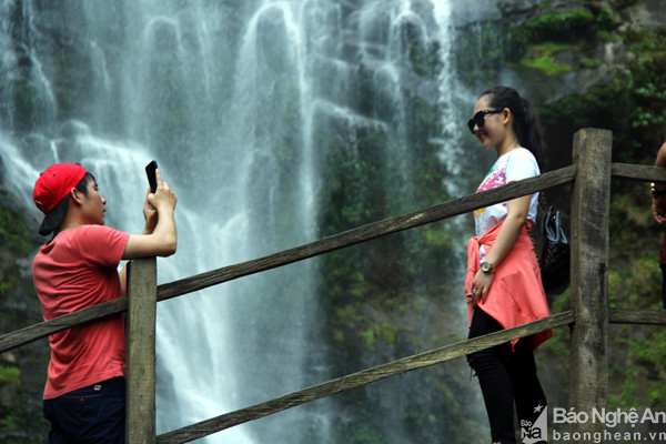 Nhiều bạn trẻ tranh thủ chụp hình kỷ niệm trước dòng thác. Một số nhóm thanh niên thậm chí mang theo đồ nhậu vào thác Khe Kèm để nghỉ ngơi. Ảnh: Tiến Hùng