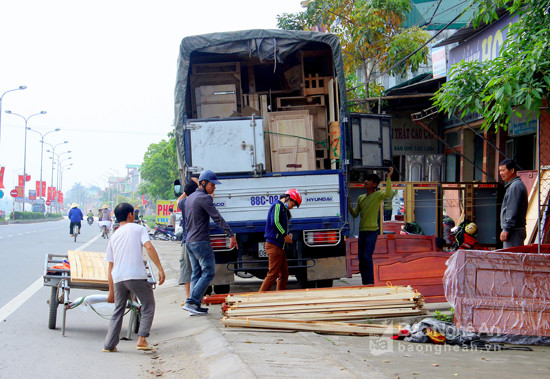 Một số hộ dân kinh doanh giường, tủ ở sát đường vô tư chiếm dụng vỉa hè làm nơi vận chuyển , bốc dỡ hàng hóa. Ảnh: Quang An