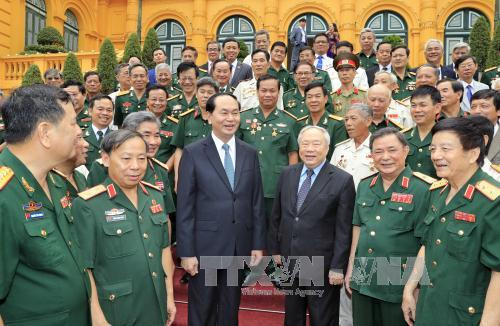 Chủ tịch nước Trần Đại Quang gặp mặt thân mật Đoàn đại biểu cựu quân tình nguyện Việt Nam giúp Campuchia. Ảnh: Nhan Sáng/TTXVN