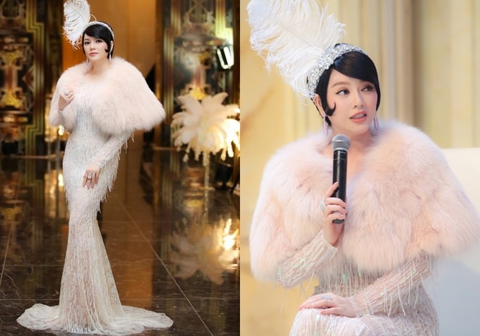 Nữ diễn viên đưa thời trang những năm 1920 trở lại trong bộ váy đuôi cá kèm áo choàng lông quý phái, tóc uốn nếp ôm sát khuôn mặt, bờm đá đính lông vũ kiêu kỳ.