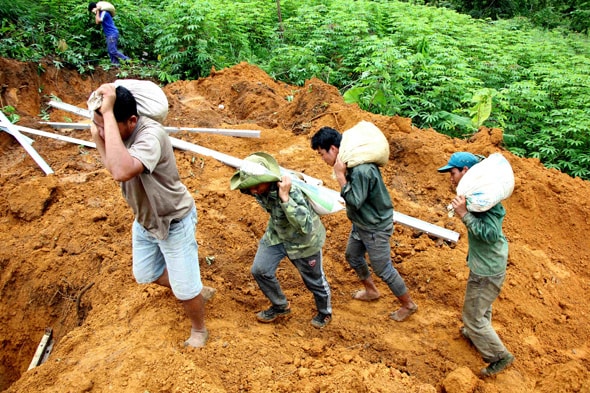 Công nhân chuyển vật liệu xây dựng khắc phục sự cố gãy cột điện cao thế. Ảnh: Hùng Cường