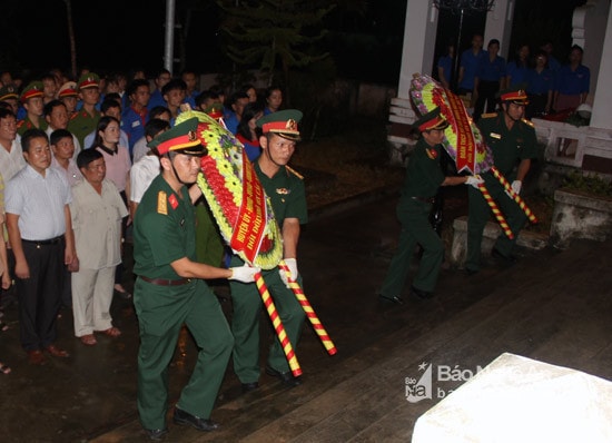 Dâng hoa lên anh linh các anh hùng liệt sỹ tại Nghĩa trang liệt sỹ Quế Phong. Ảnh: Hồ Phương