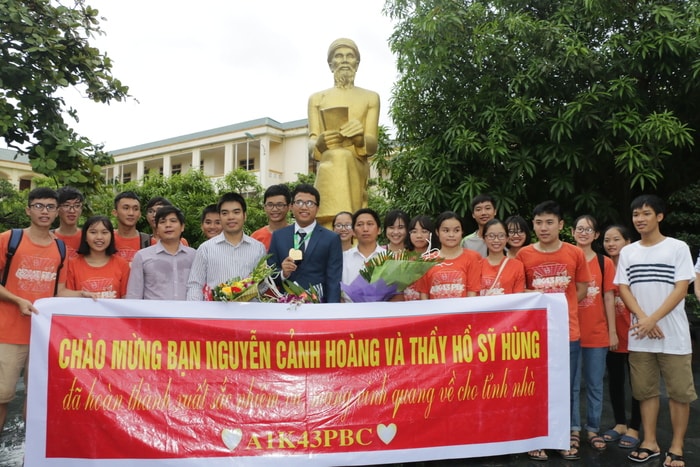 Huy chương Vàng Olympic Toán học quốc tế Nguyễn Cảnh Hoàng cùng thầy giáo và các bạn học sinh tại lễ đón học sinh giỏi. Ảnh: Mỹ Hà