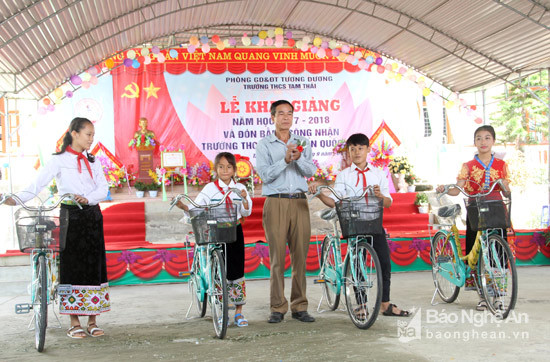 Lãnh đạo xã Tam Thái (Tương Dương) trao tặng xe đạp cho các em học sinh nghèo vượt khó. Ảnh: Hồ Phương.