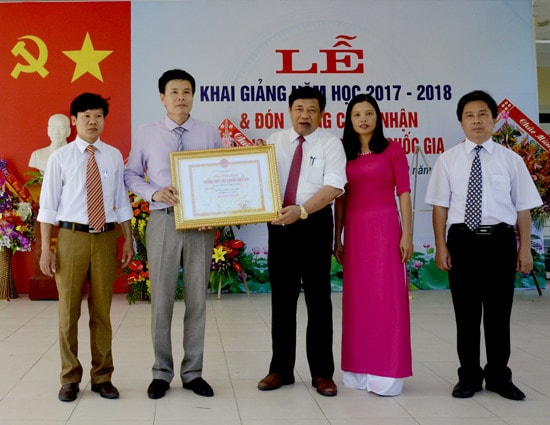 Đồng chí Nguyễn Xuân Đường - Phó Bí thư Tỉnh ủy, Chủ tịch UBND tỉnh trao Bằng công nhận đạt chuẩn quốc gia cho Trường THPT Kim Liên (Nam Đàn). Ảnh: Thanh Lê