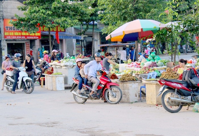 Con đường vào chợ trung tâm tại khối 4, thị trấn Kim Sơn mọc lên nhiều xe bán hoa quả lưu động, nhiều người đã dừng lại mua hàng khiến giao thông có thời điểm bị ùn tắc, dễ gây tai nạn. Ảnh : Quang An