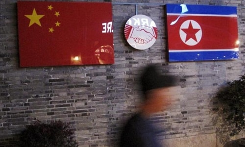 Flags of China and North Korea are seen outside the closed Ryugyong Korean Restaurant in Ningbo, Zhejiang province, China, in this April 12, 2016 file photo. © 2016 Reuters