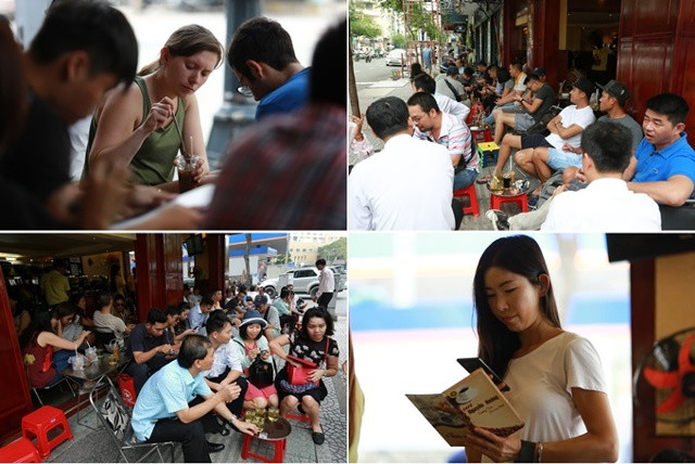 Khách nước ngoài sử dụng phần mềm trên điện thoại để dịch menu tiếng Việt - Ảnh: Nguyễn Thành