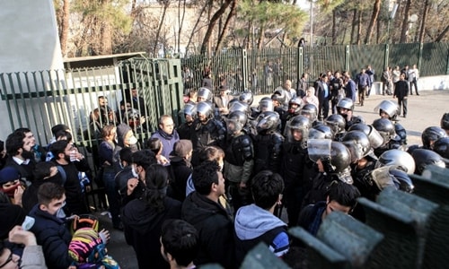 Iranian students scuffle with police at the University of Tehran during a demonstration driven by anger over economic problems, in the capital Tehran on December 30, 2017. Students protested in a third day of demonstrations, videos on social media showed, but were outnumbered by counter-demonstrators.