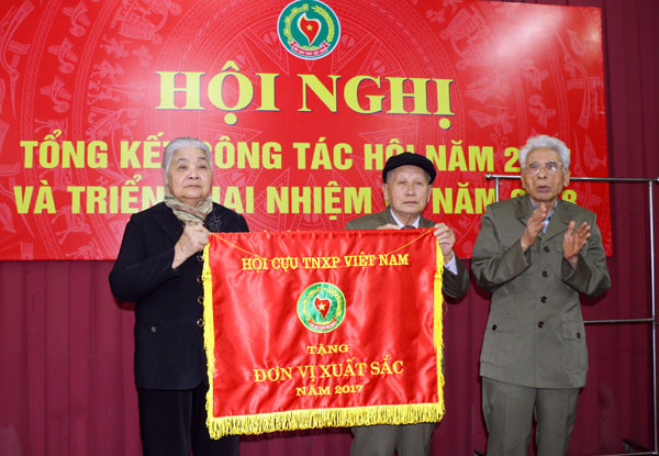 Tặng cờ thi đua của Hội cựu TNXP Việt Nam cho hội cựu THXP tỉnh. Ảnh - Mỹ Hà