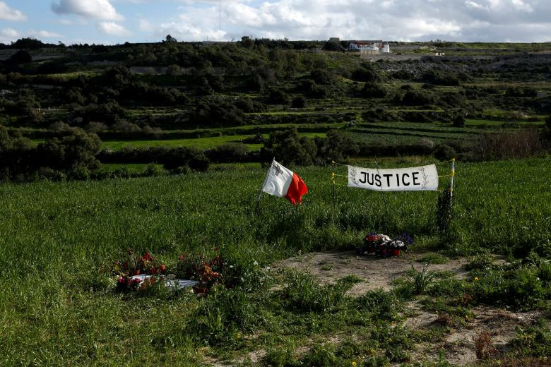 A Maltese flag and banner calling for justice are seen at the scene of the assassination of anti-corruption journalist Daphne Caruana Galizia, one hundred days after her murder in a car bomb explosion, in Bidnija, Malta, January 24, 2018. REUTERS/Darrin Zammit Lupi