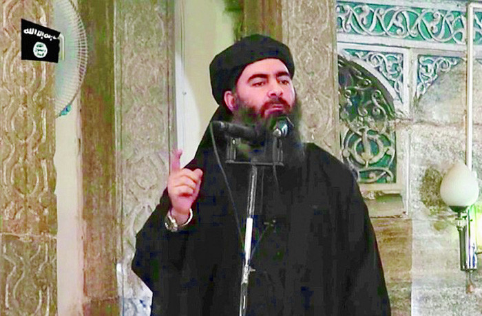 Tên thủ lĩnh IS Abu Bakr al-Baghdadi trong lần xuất hiện hiếm hoi tuyên bố ra đời Nhà nước Hồi giáo - Ảnh: REUTERS