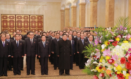  Nhà lãnh đạo Triều Tiên Kim Jong-un (đứng hàng đầu) và các quan chức tại Cung Kumsusan ngày 16/2. Ảnh: Rodong Sinmun.