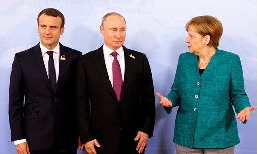 Từ trái qua, Tổng thống Pháp Emmanuel Macron, Tổng thống Nga Vladimir Putin và Thủ tướng Đức Angela Merkel. Ảnh: Reuters.