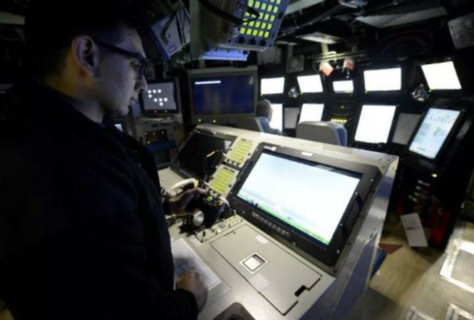 rung tá Anthony Matus đang sử dụng tay cầm Xbox để điều khiển kính tiềm vọng quang điện tử trên tàu ngầm Colorado. Ảnh: US Navy
